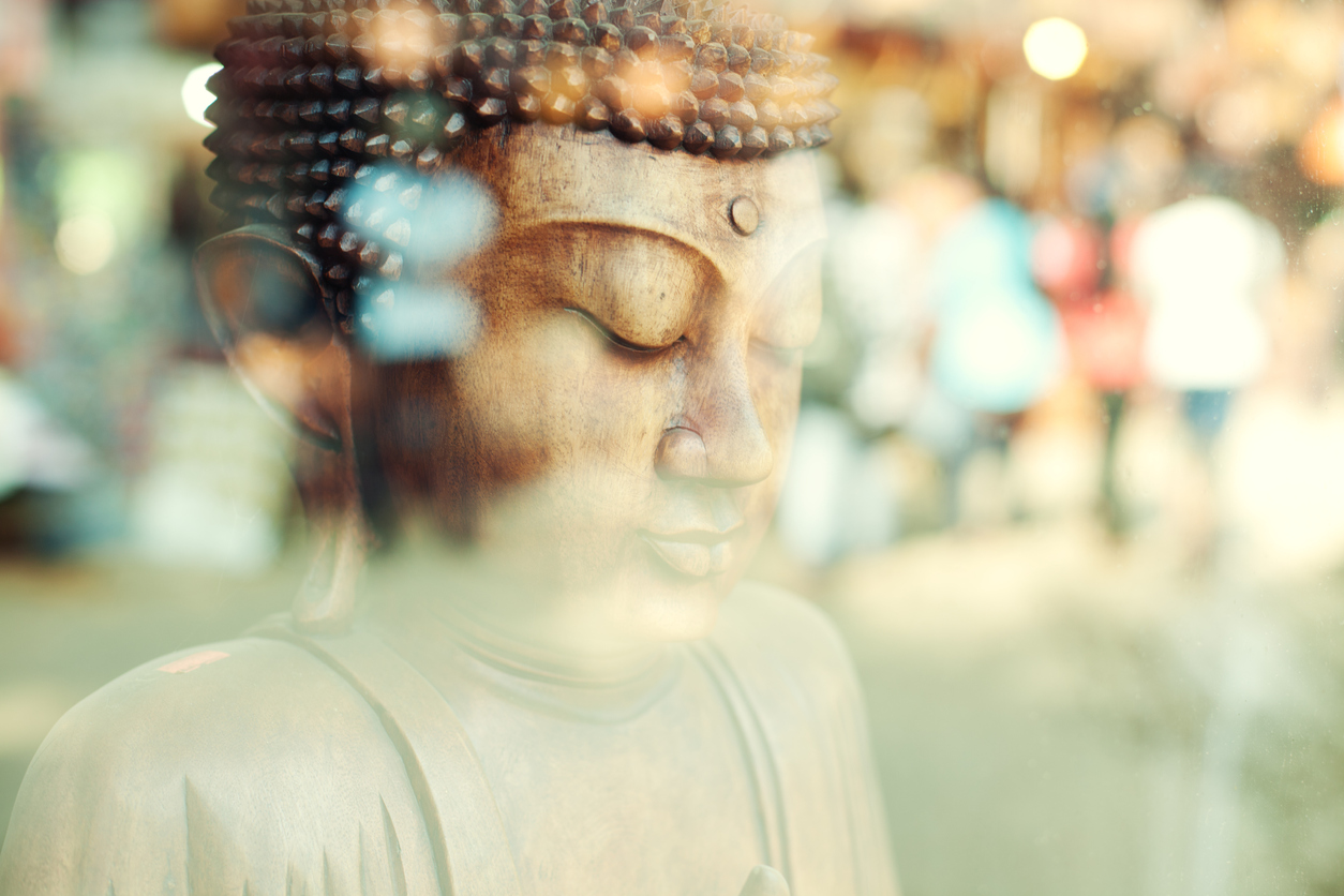 Close-up of a Buddha statue (Sri Lanka) Close up of a Sri Lankan wooden Buddha statue in a window display.